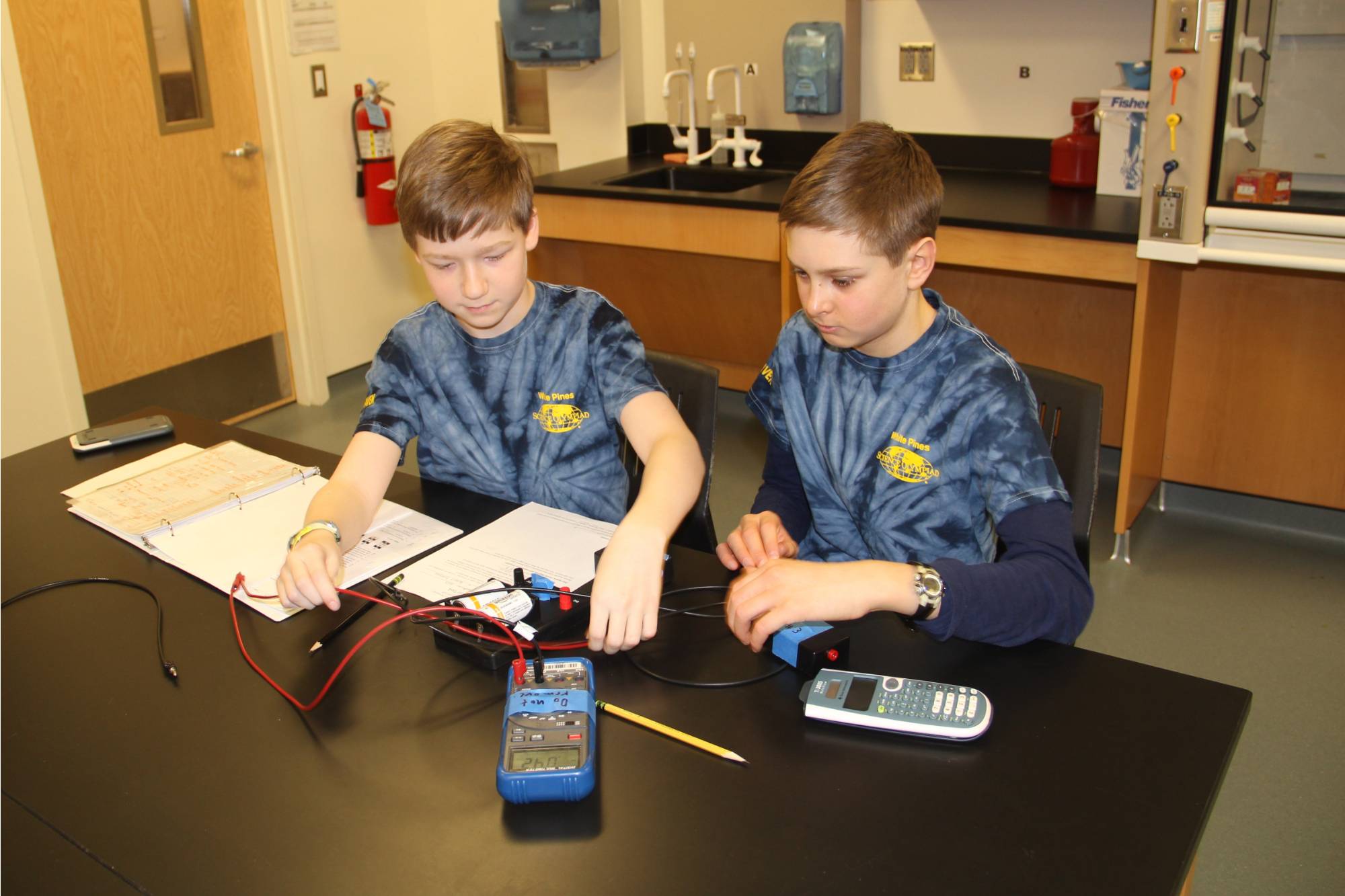 Students testing electric currents during MSO Competition